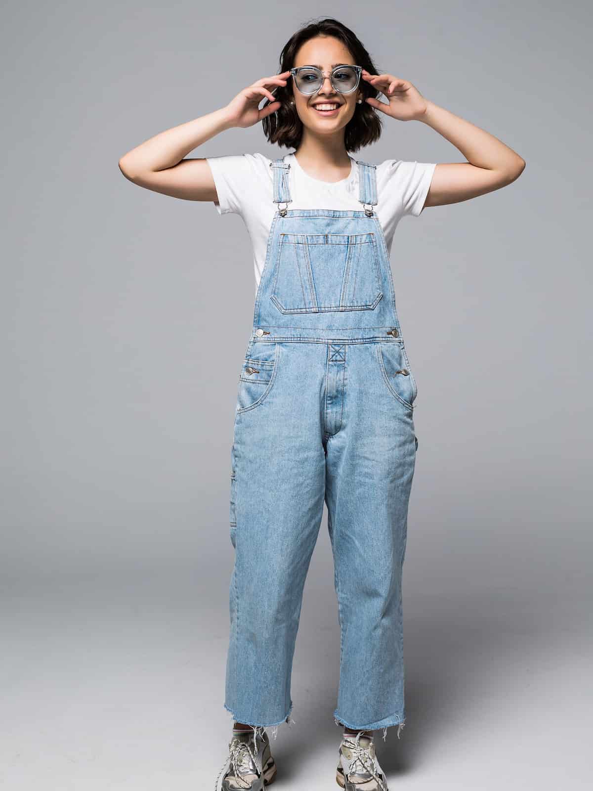 woman wearing overalls with sunglasses.