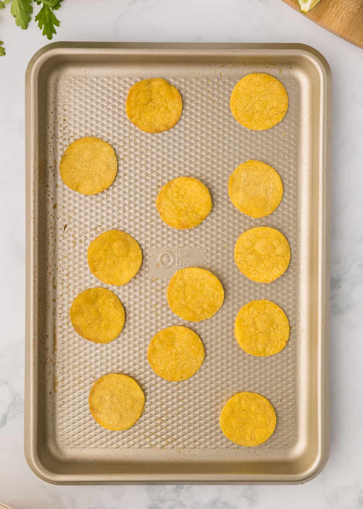 Corn tostadas baked on sheet pan.