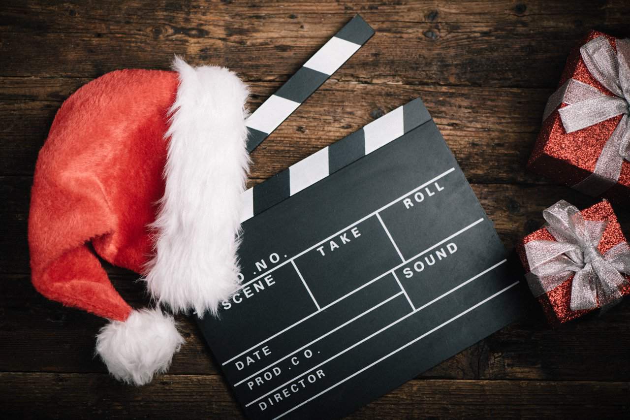 christmas-hat-with-film-board-cutout-wooden-table.