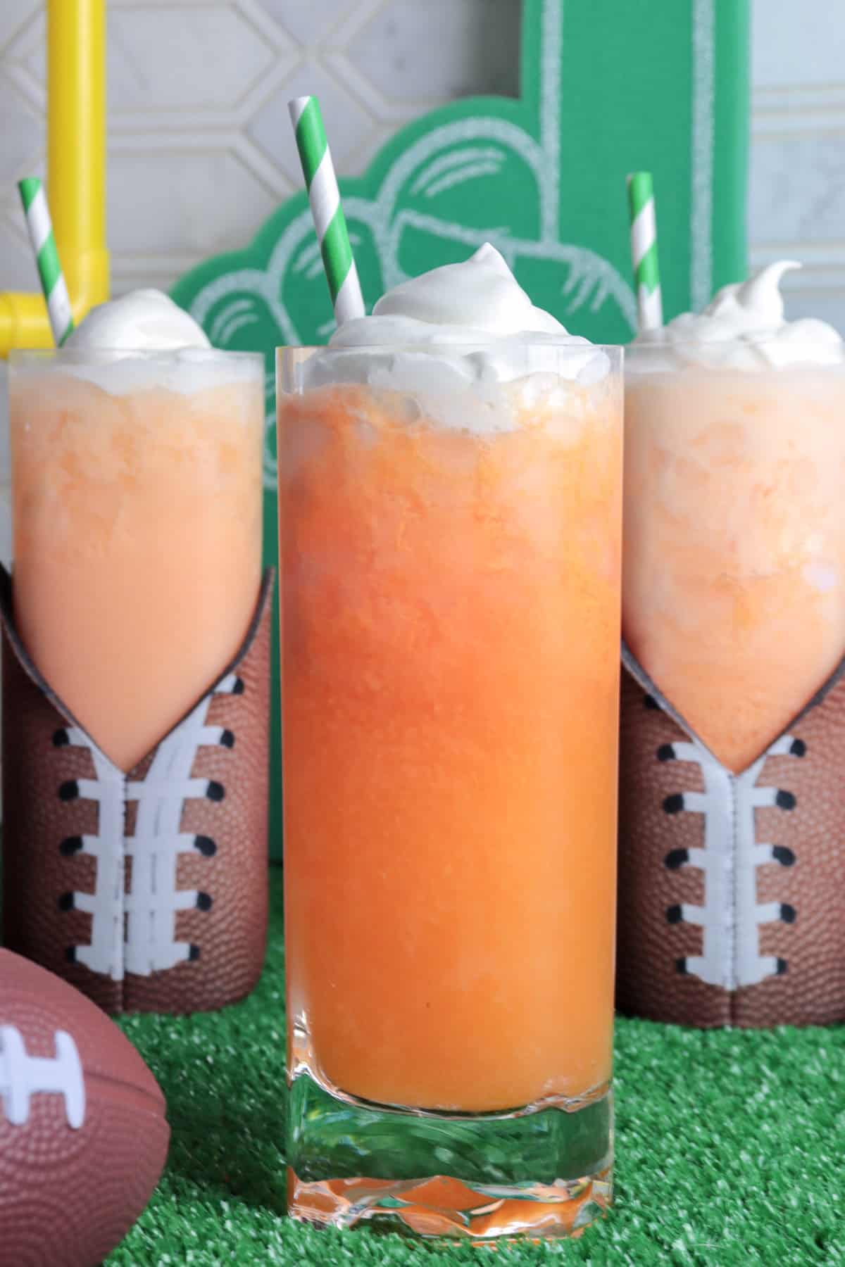 Orange creamsicle soda on green astroturf.