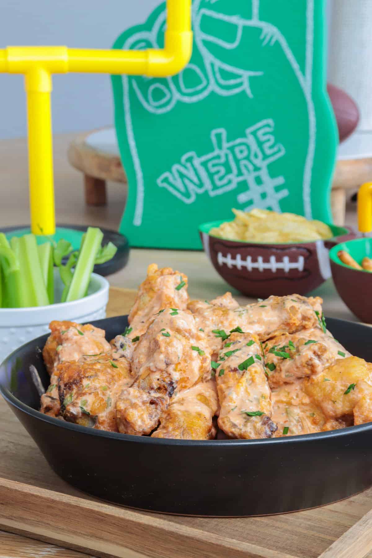 Football appetizer table with chicken wings and chips.