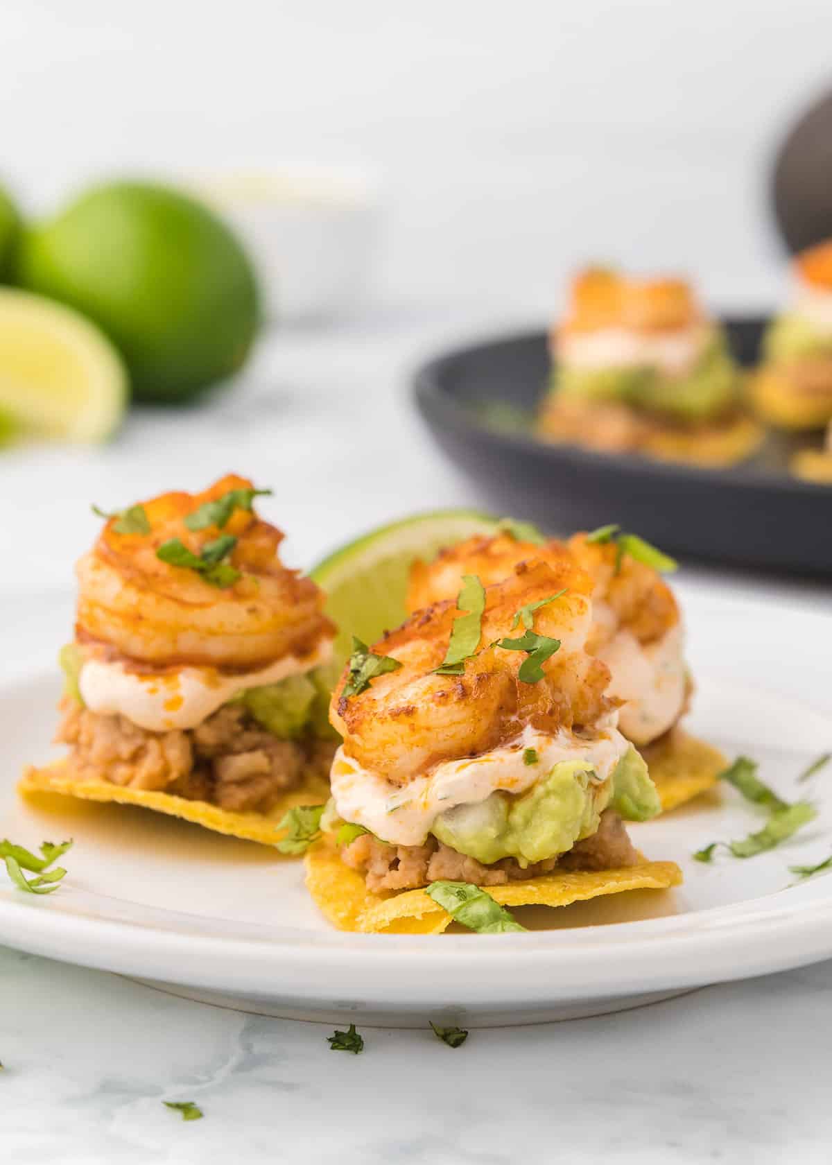 Mexican tostadas appetizer with shrimp on a plate.