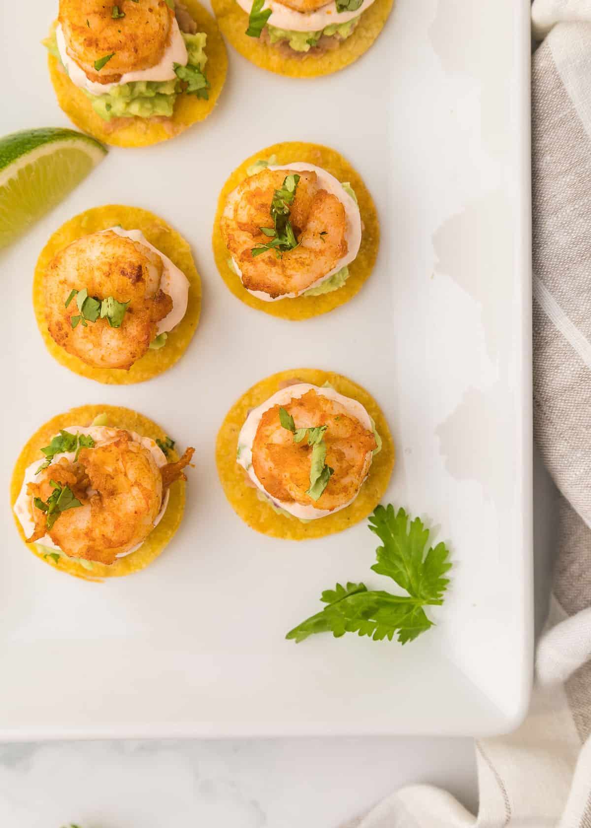 Shrimp tostadas appetizer with parsley.