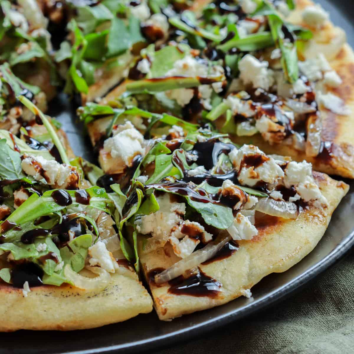 Flatbread with arugula, feta and onions.
