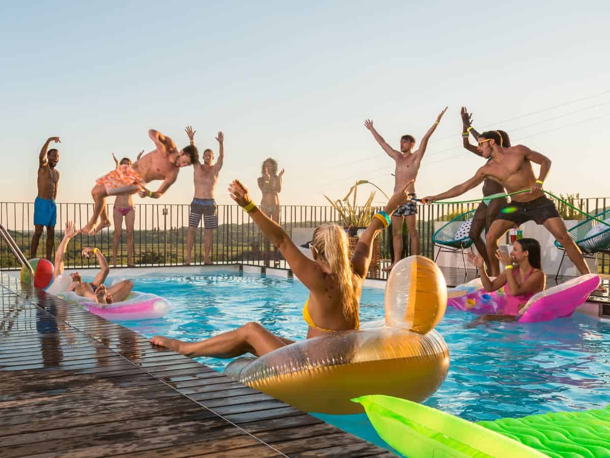 People having fun in a pool at a party.