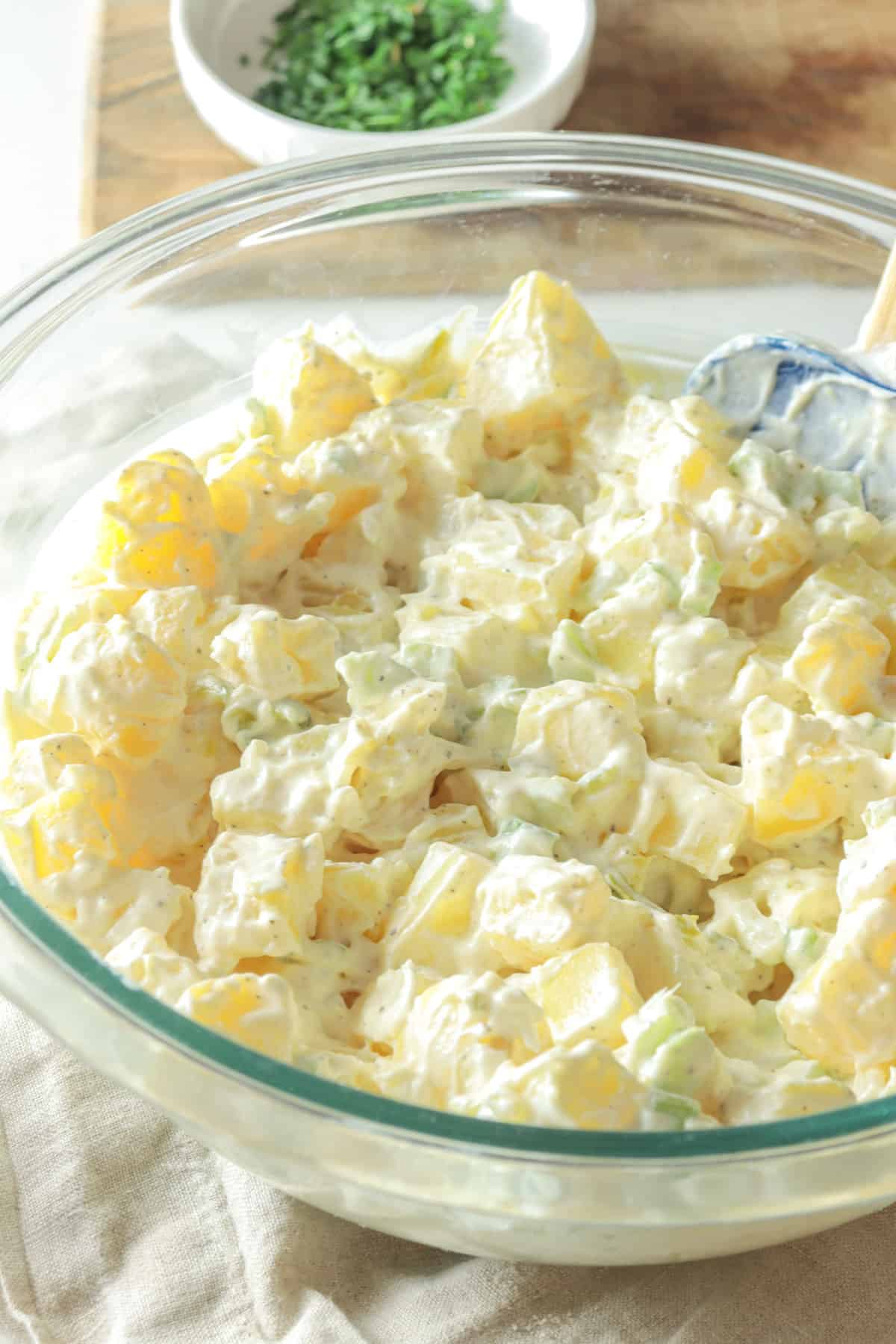 Creamy potato salad with sour cream before adding toppings.