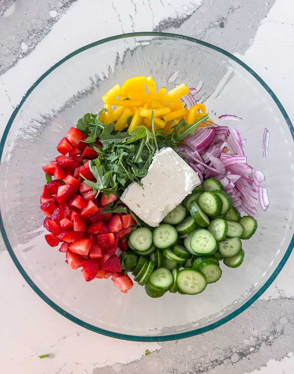 Arugula salad ingredients in a bowl.