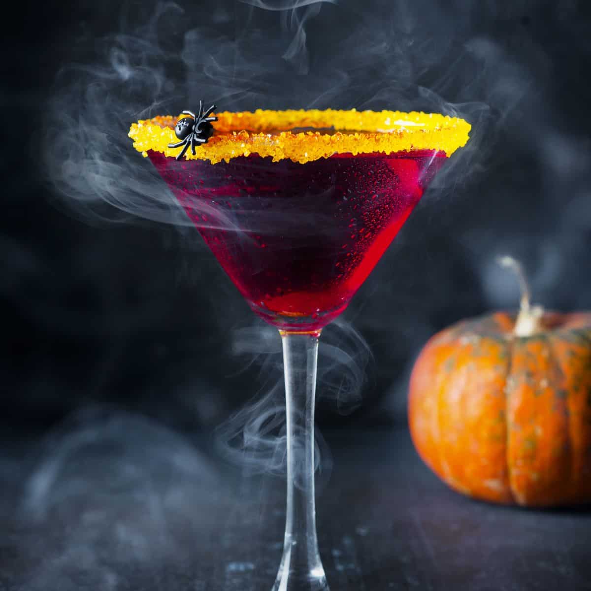 Red Halloweem martini with spider on rim.