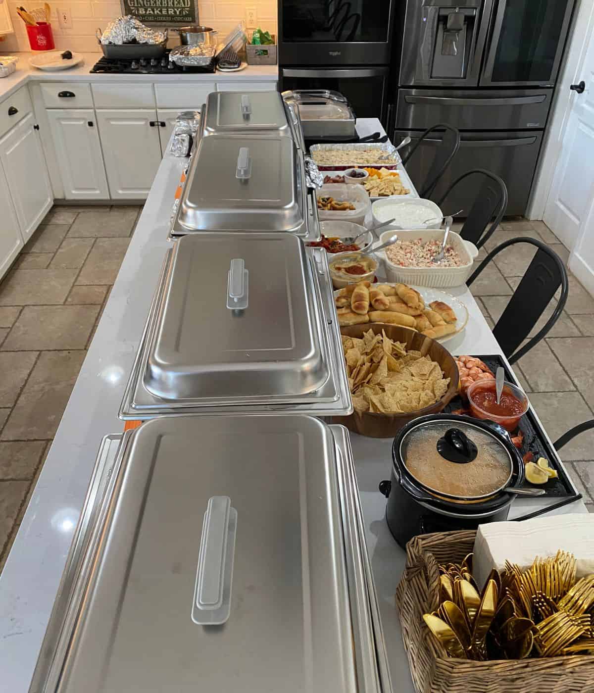 Thanksgiving buffet table set with chafing dishes.