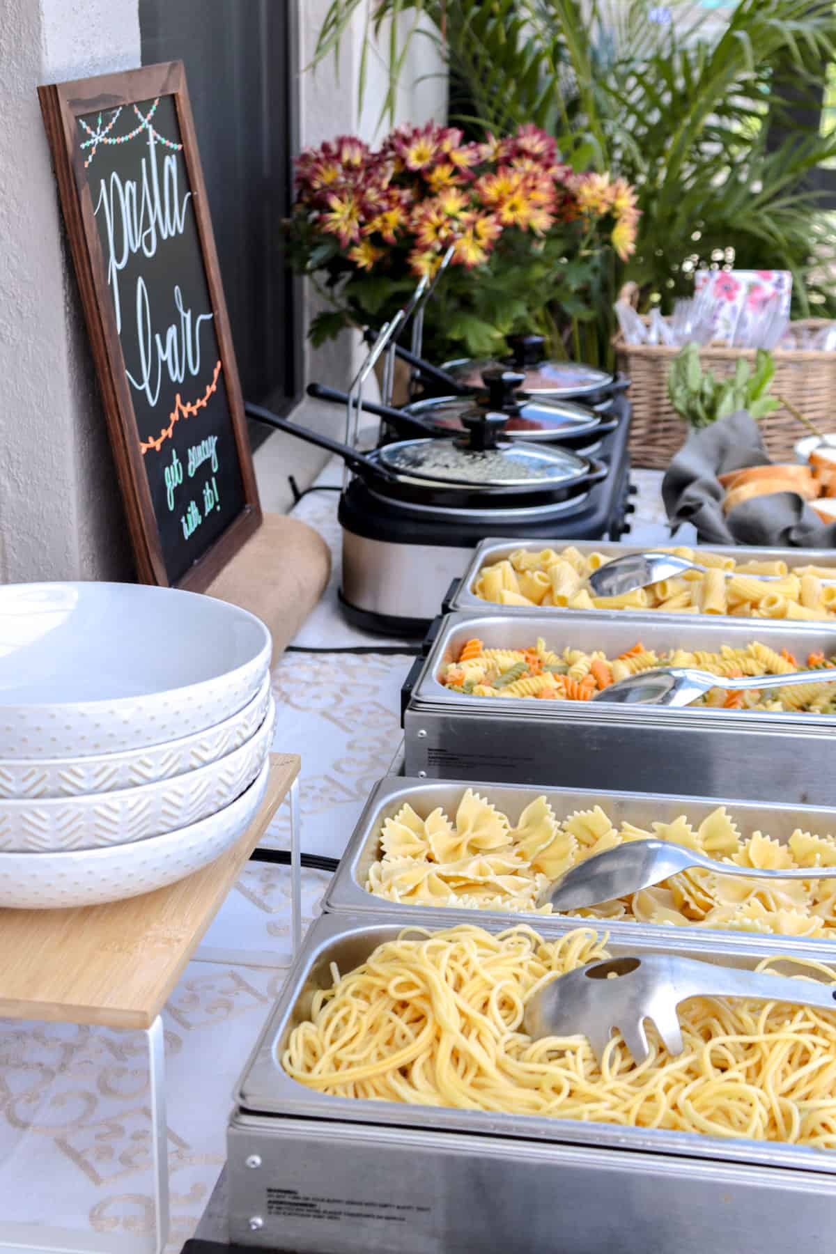 Pasta ready to be served in chafing dishes.