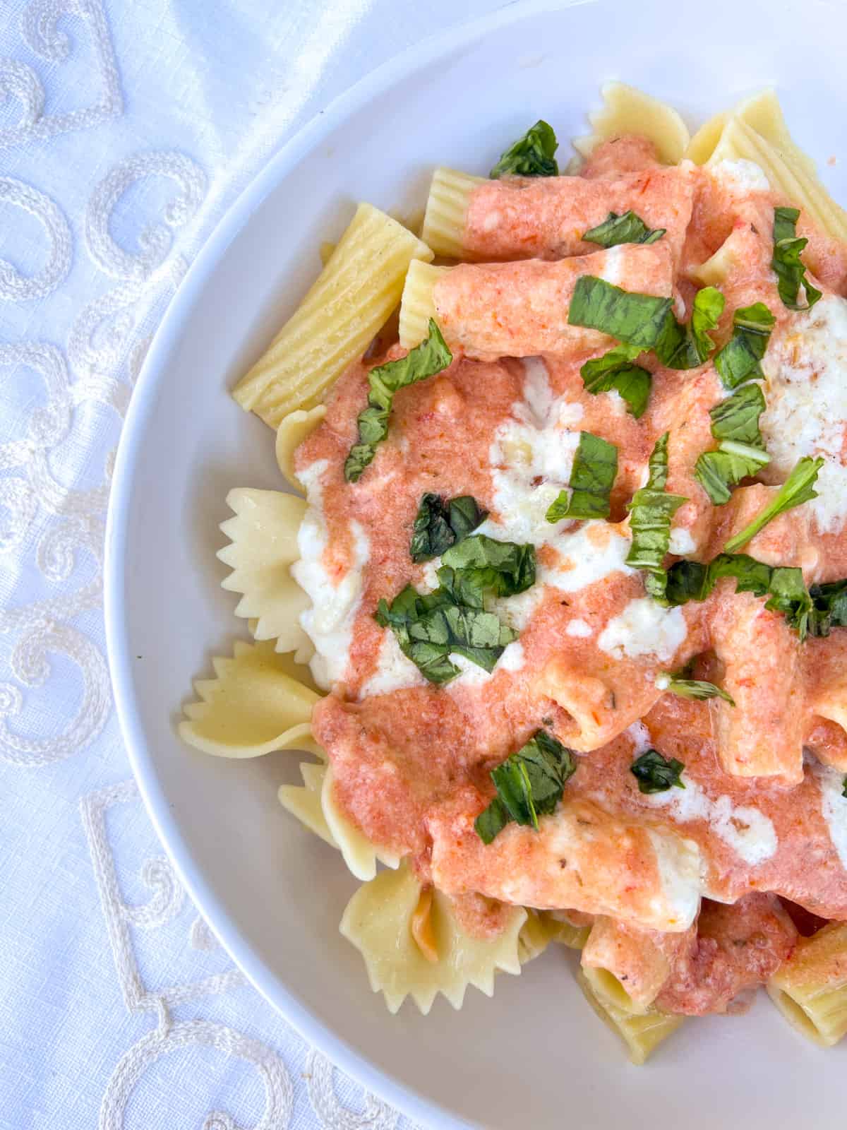 Rigatoni with sauces and basil.