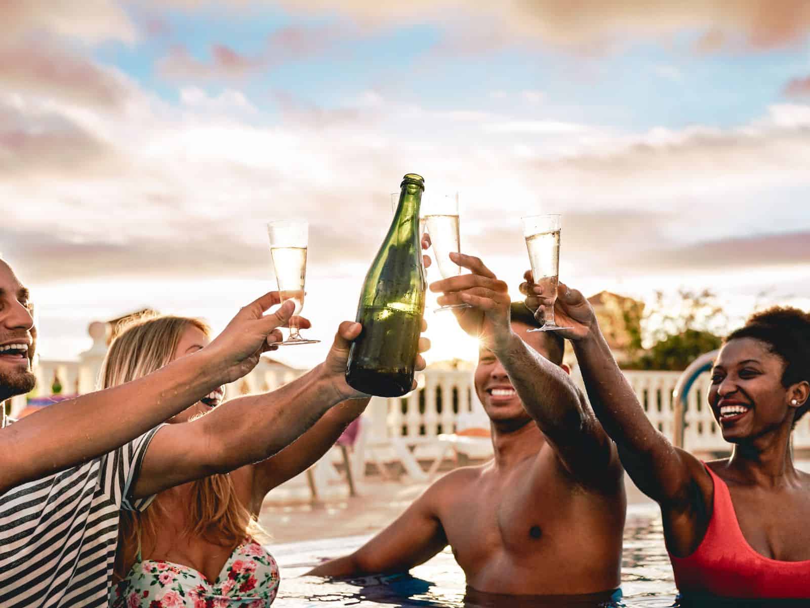 Toasting champagne in a pool.