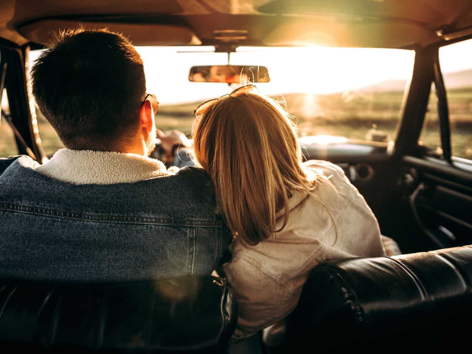Couple on a road trip in a car.