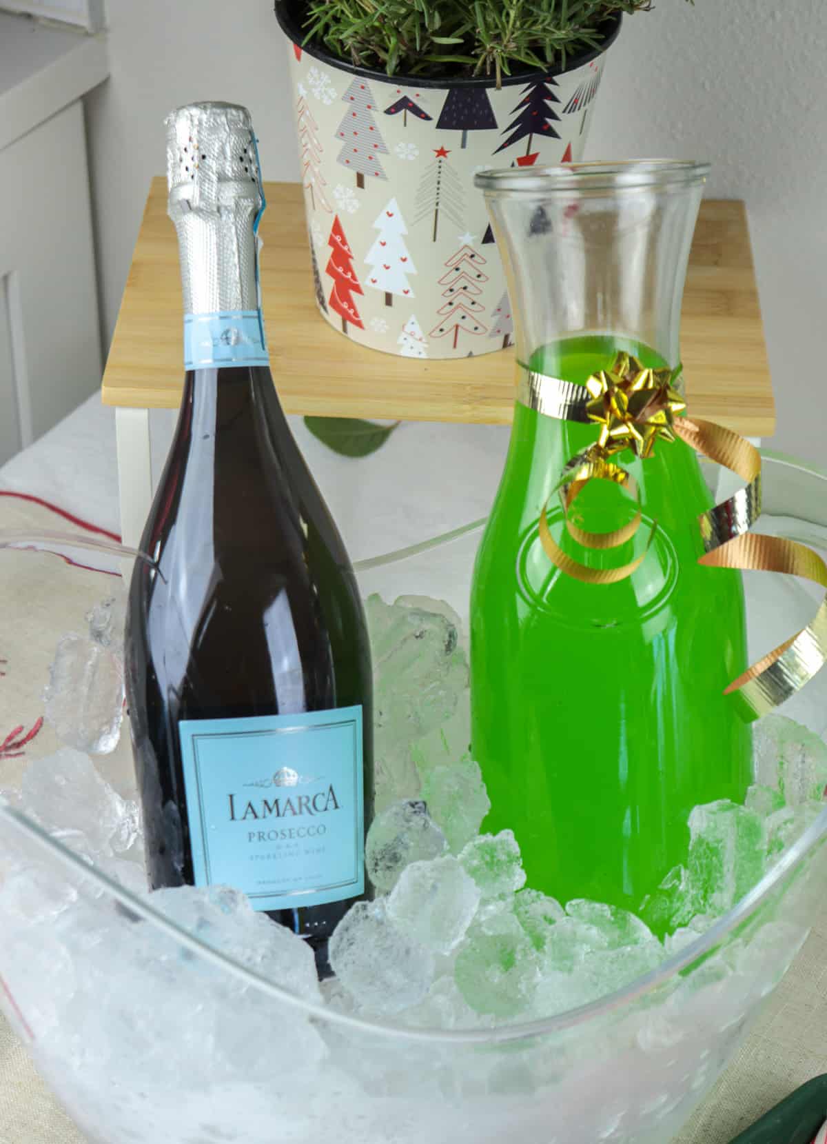 Prosecco and green juice in carafes over ice.