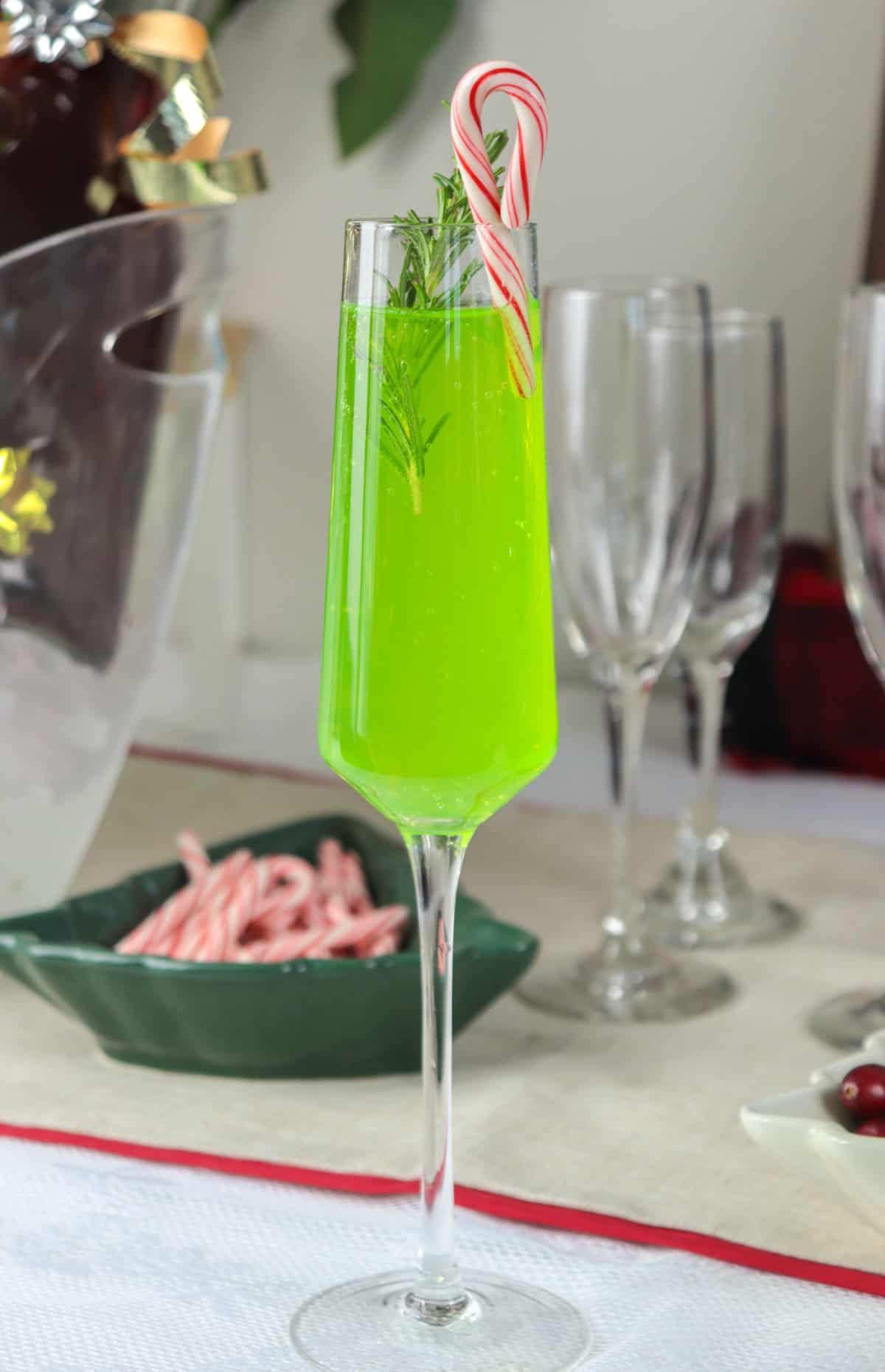 Grinch mimosa on table with candy cane.