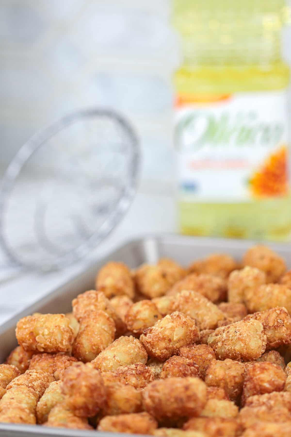 Fried tater tots in pan.