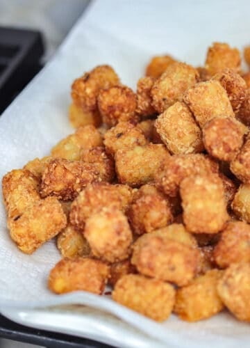 Fried tater tots with paper towel.