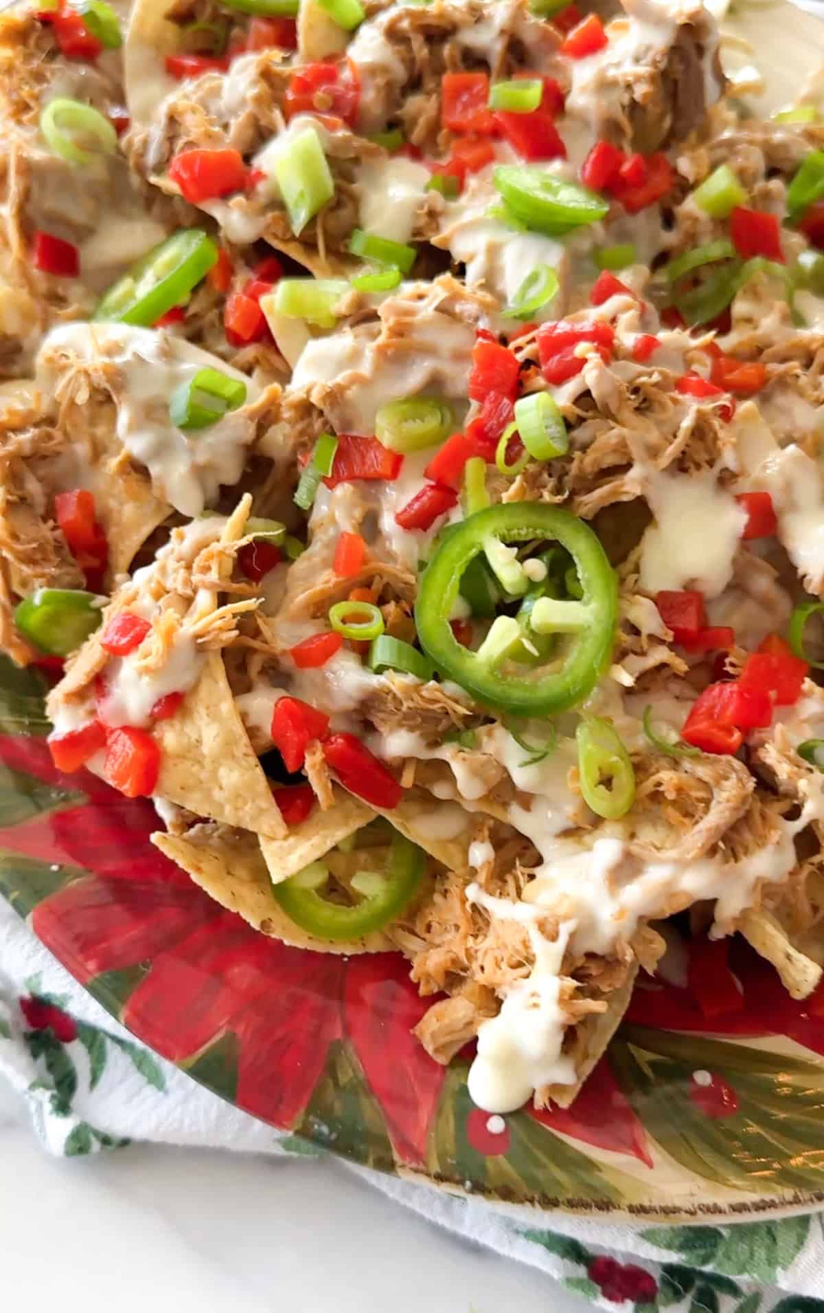 Pork nachos with red peppers and jalapenos.