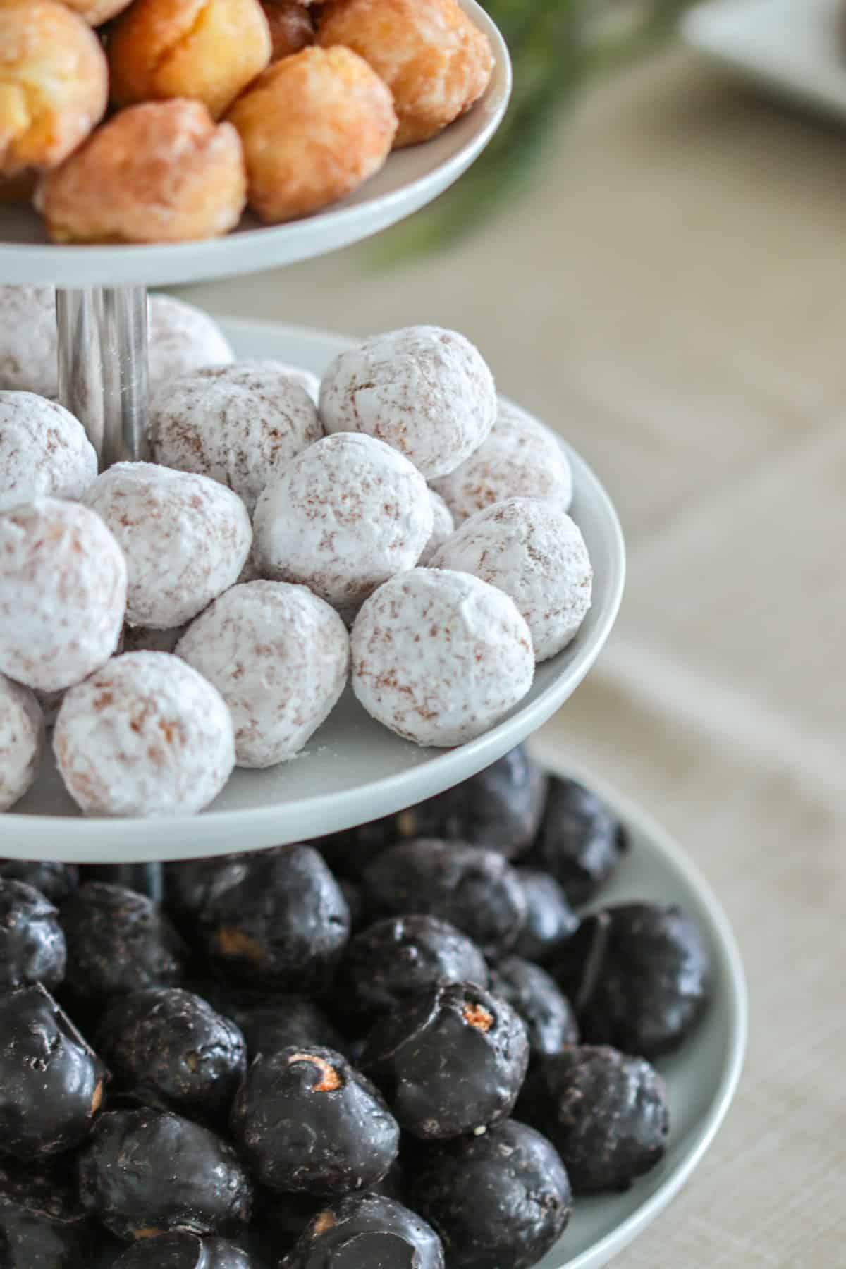 Donuts on tiered serving platter.