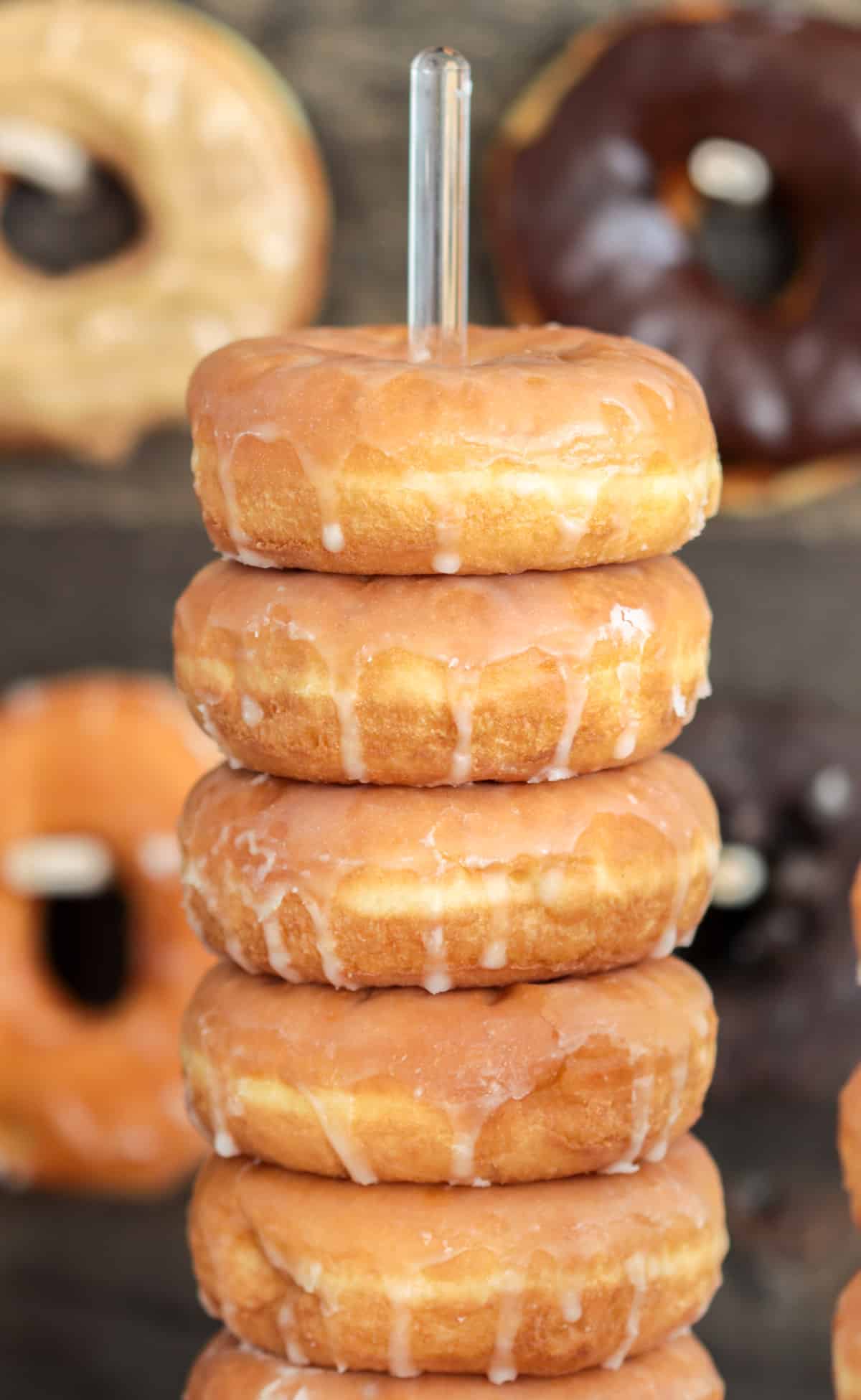 Donuts stacked on acrylic stand.