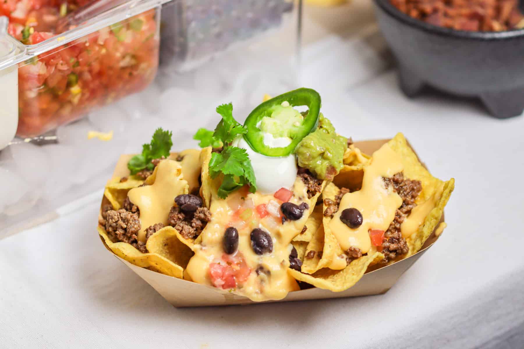 Loaded nacho plate on nacho bar.