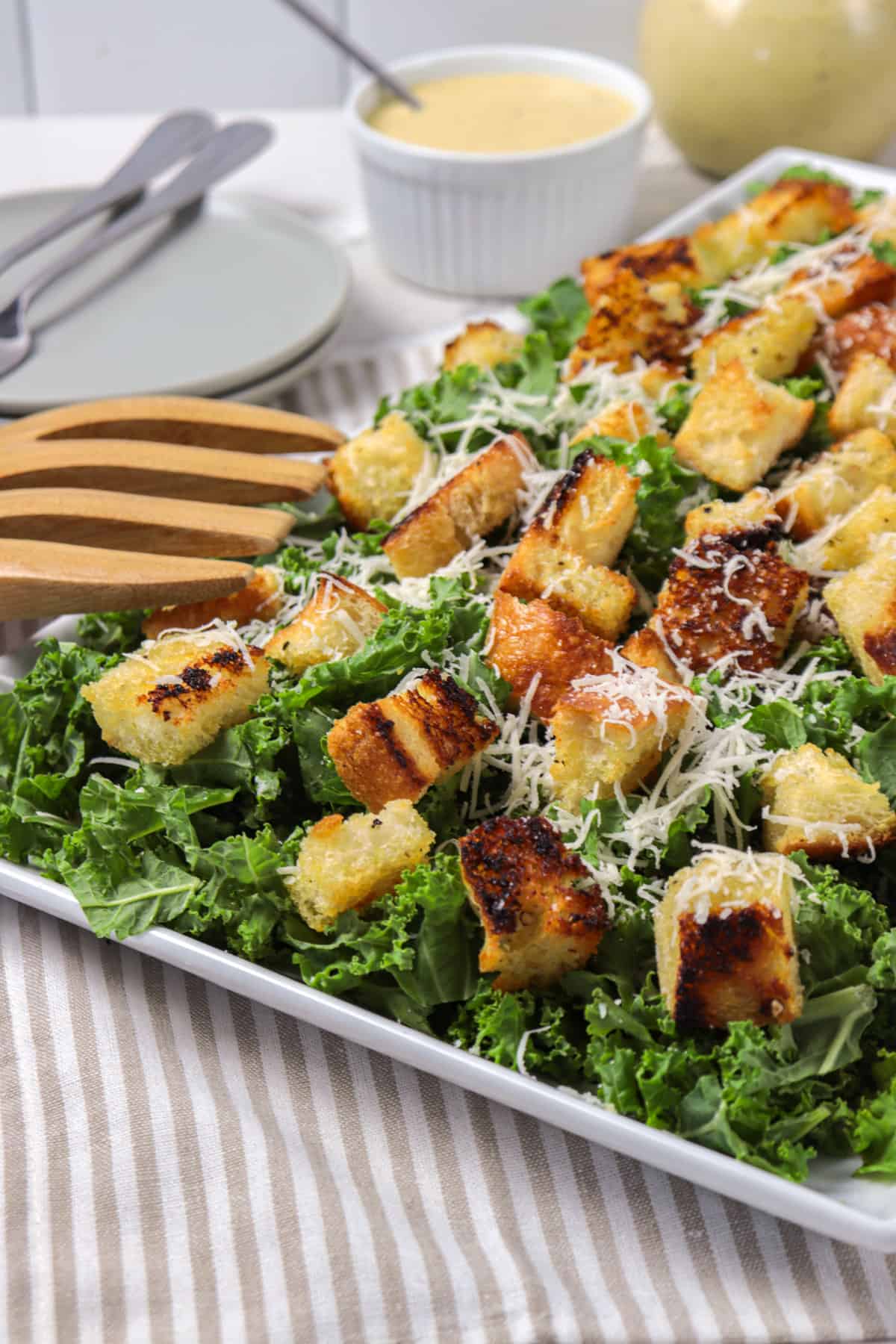 Kale Caesar salad with croutons and Parmesan cheese.