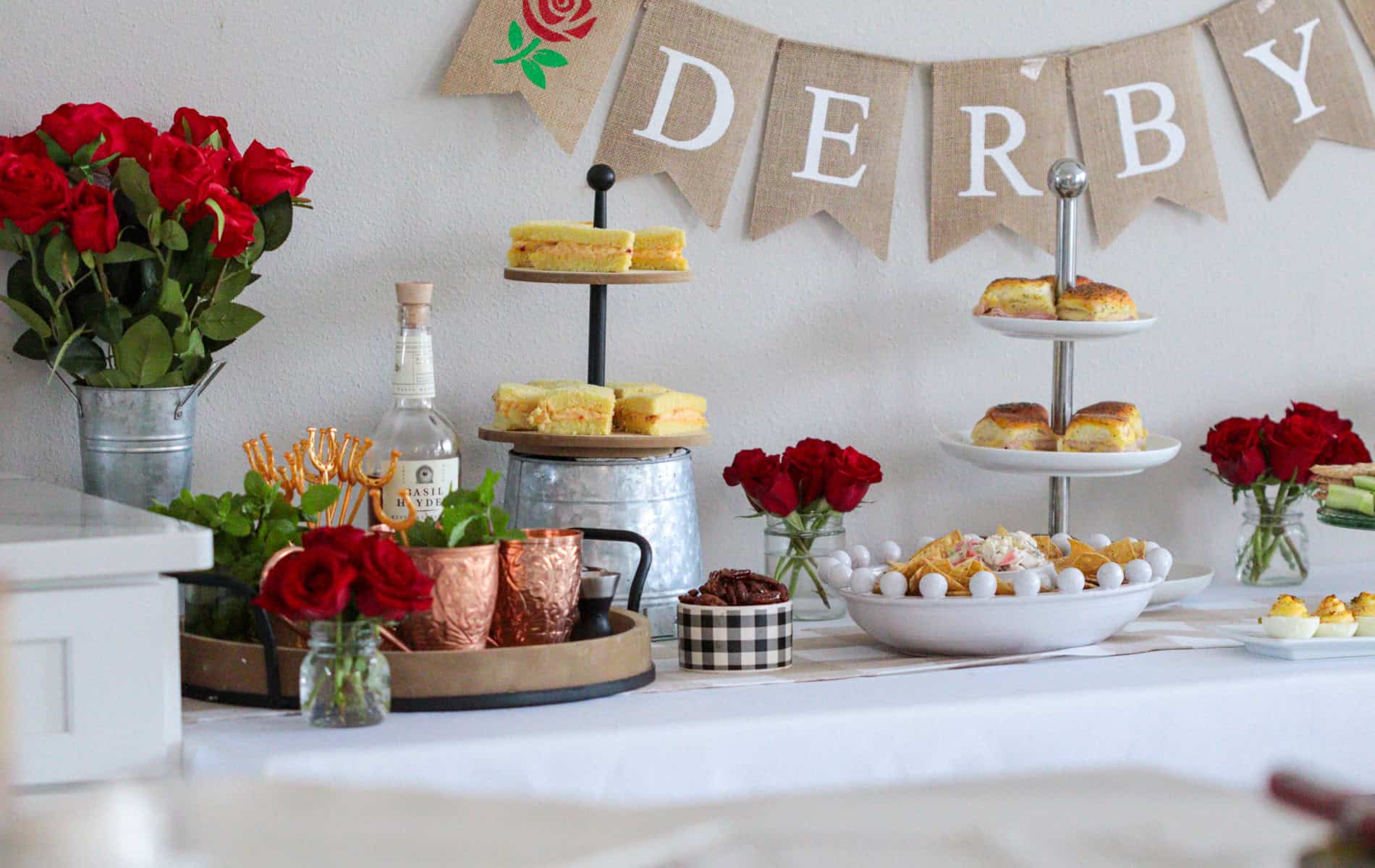 Kentucky derby table with food and banner.