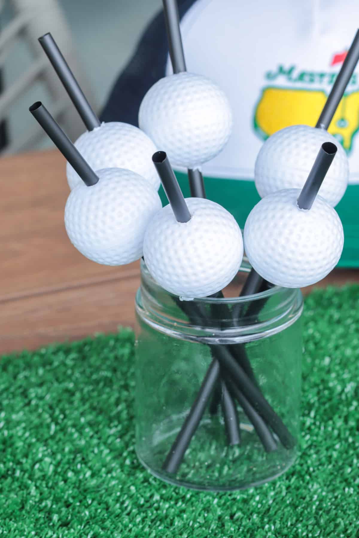 Golf balls on a black straw.