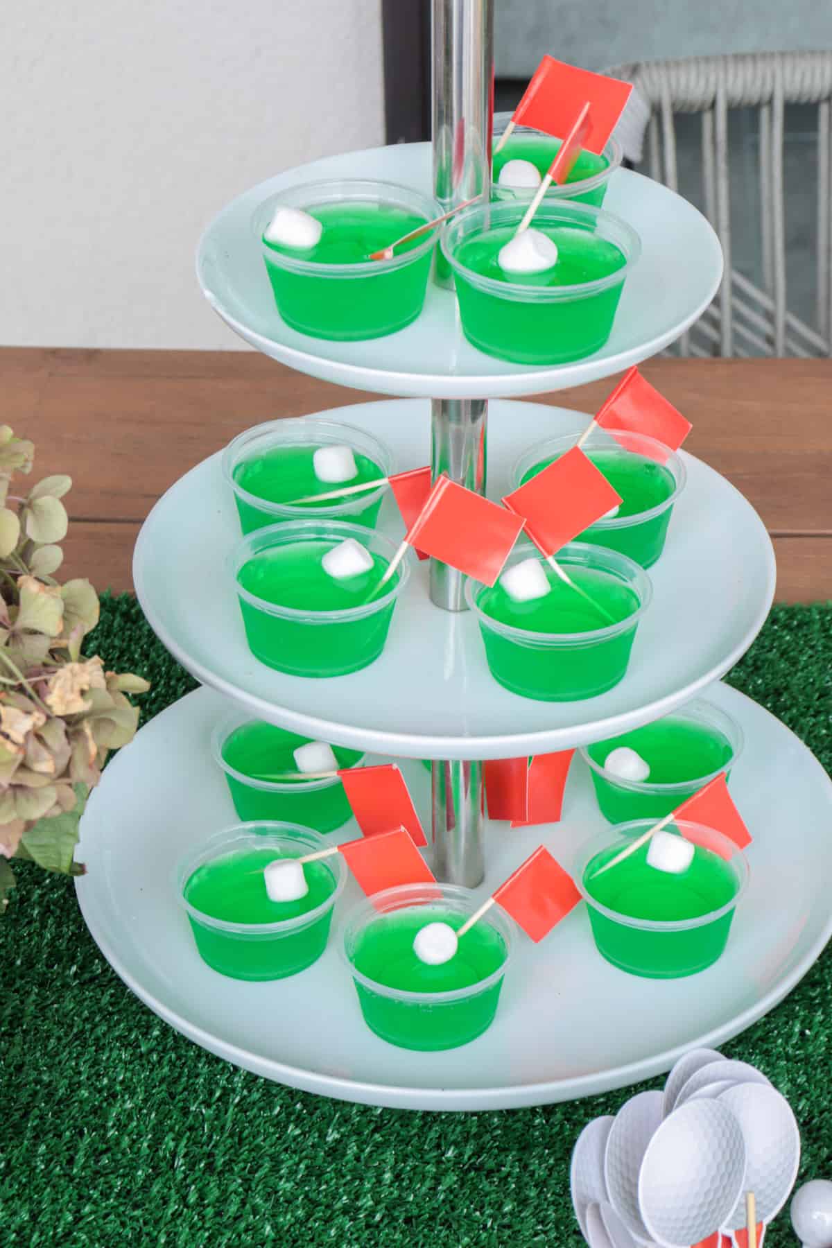 Green Jello shots with red flags and white marshmallow ball.