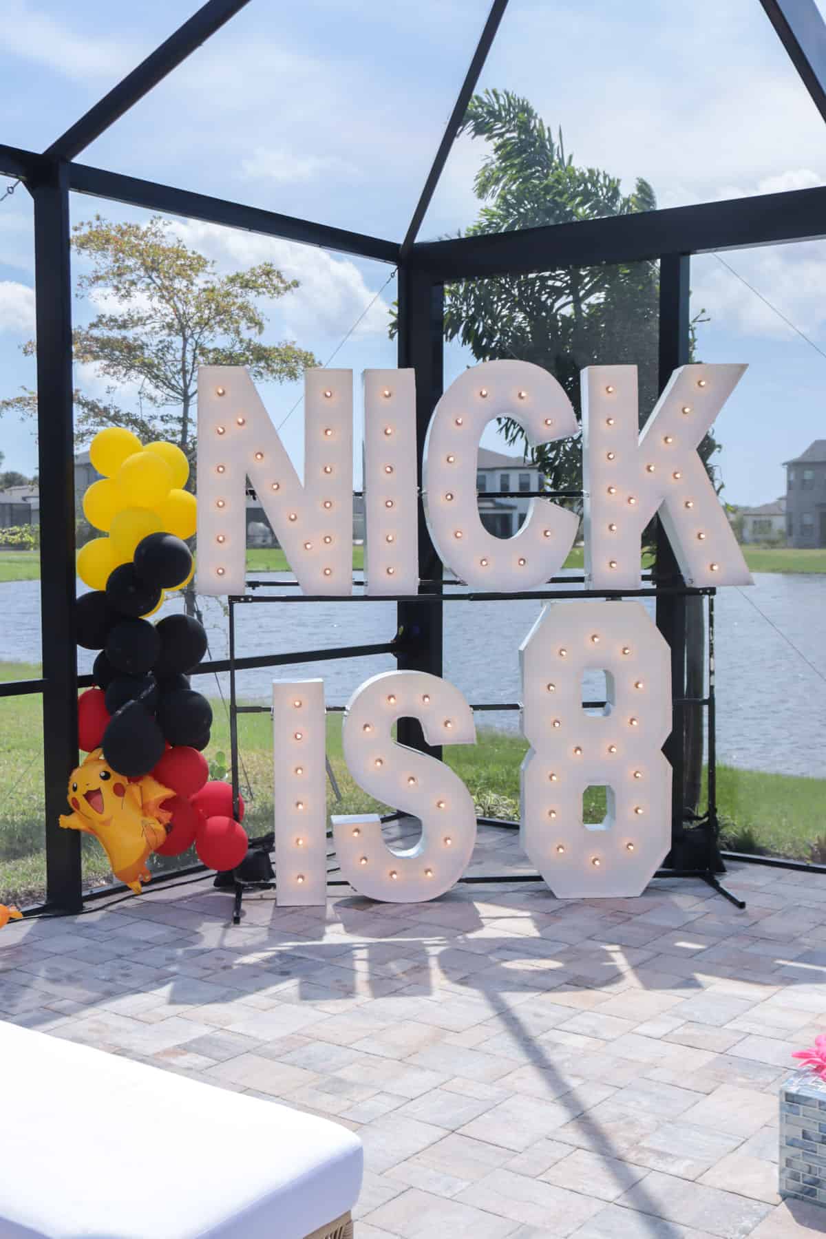 Light letters stacked spelling "nick is 8".