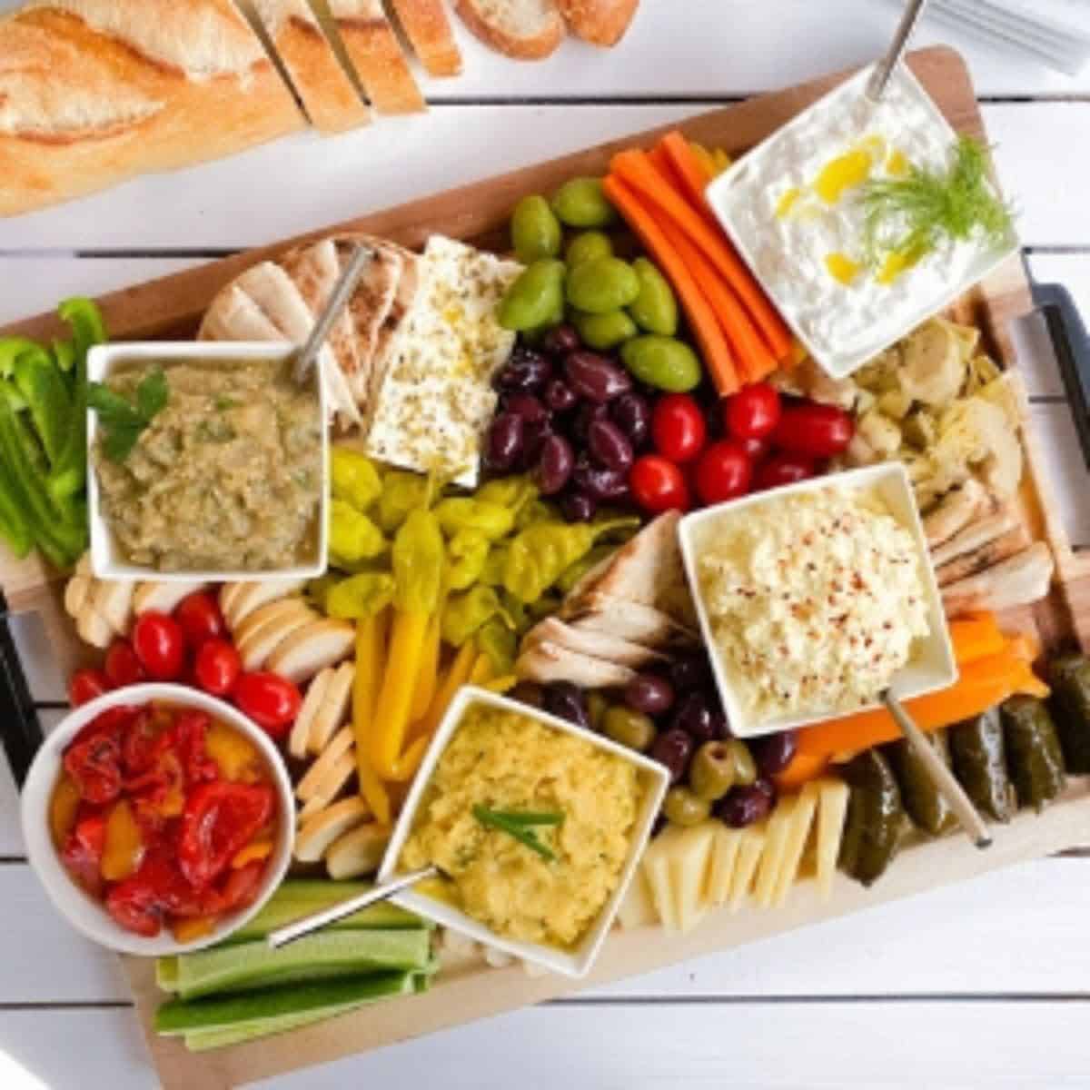 Greek appetizer spread on a cutting board.