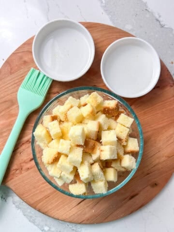 Angel food cake cut up into cubes.