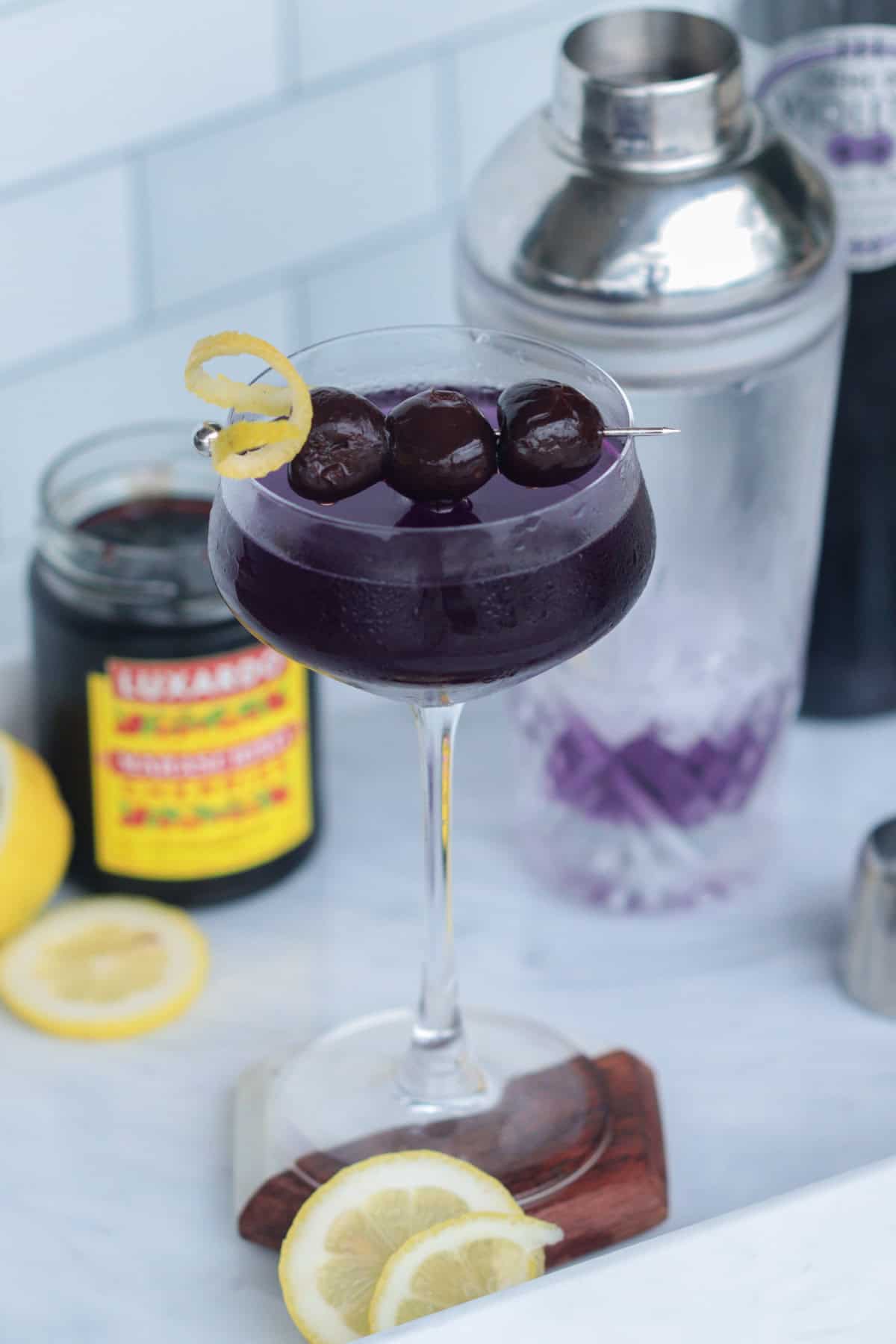 Aviation cocktail with bourbon cherries.