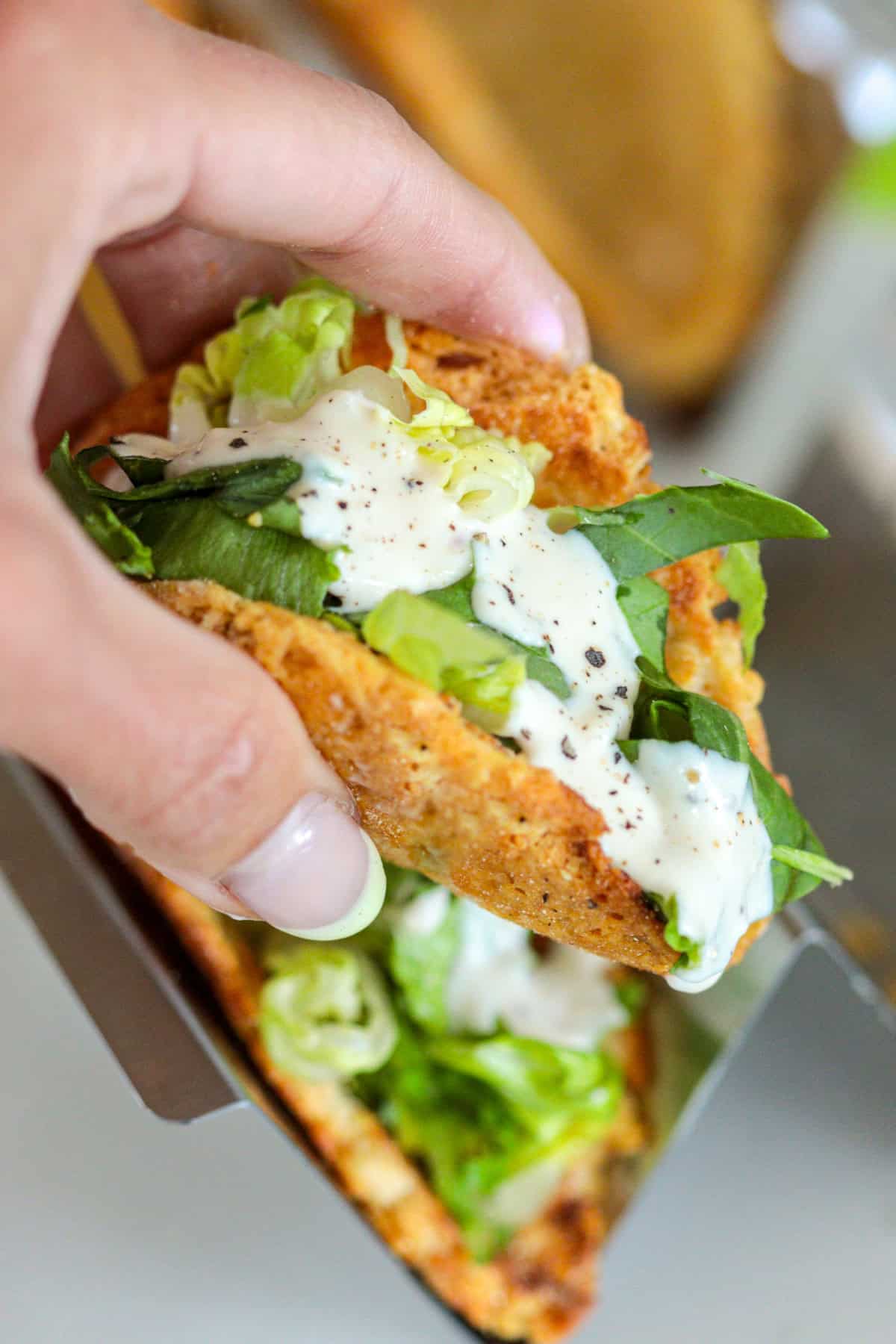 Close up of Caesar salad taco.