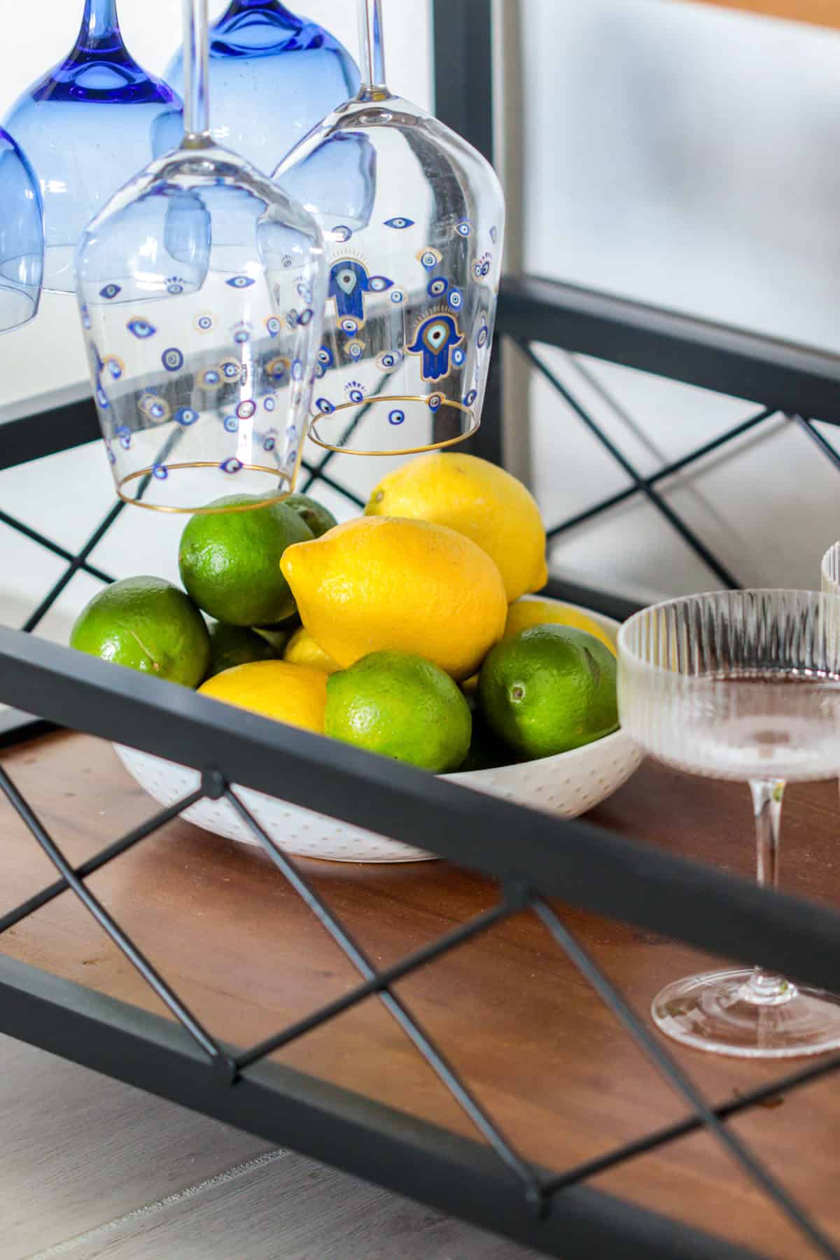 Bar cart with citrus and glasses.