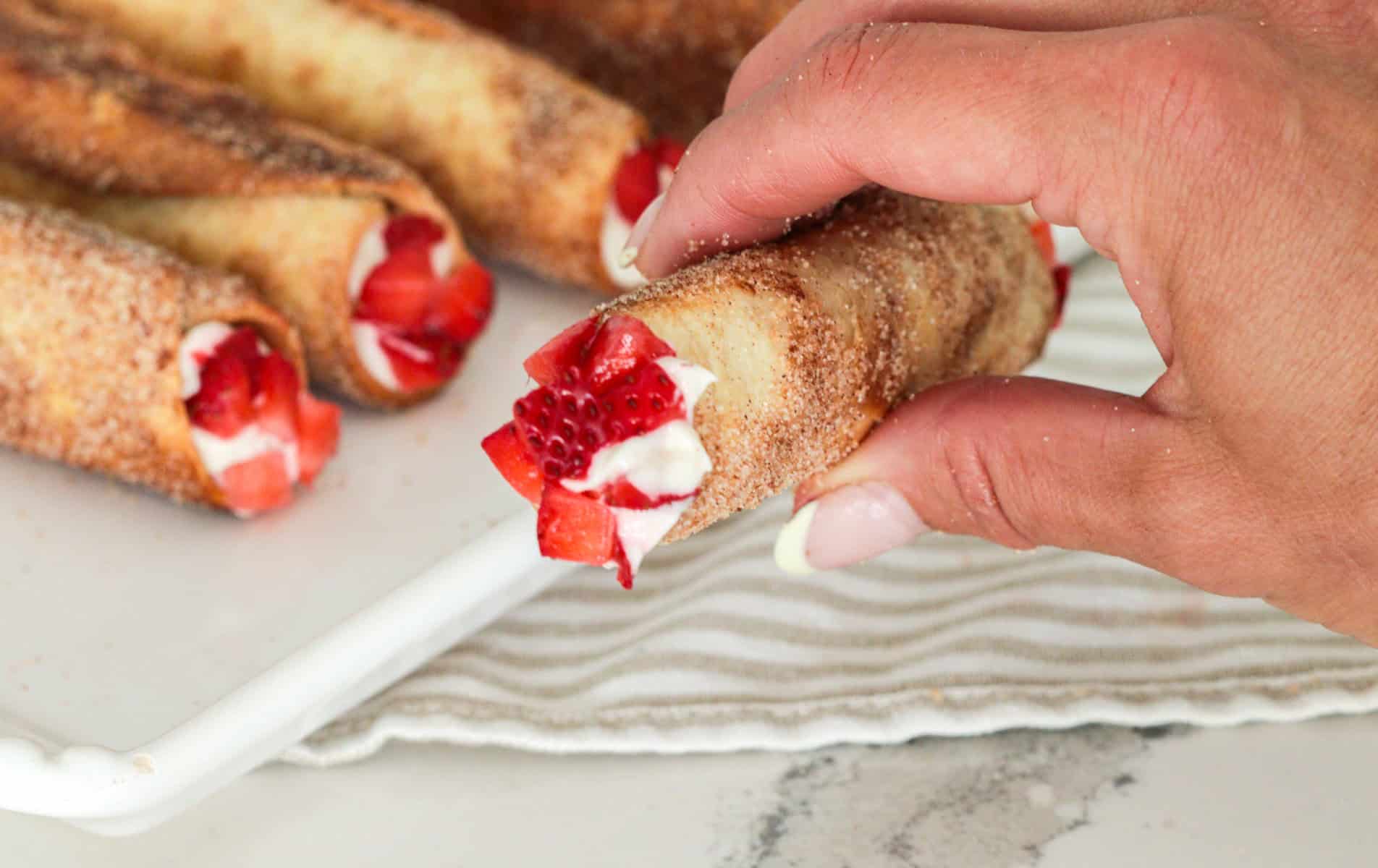 Holding cheesecake cigar.