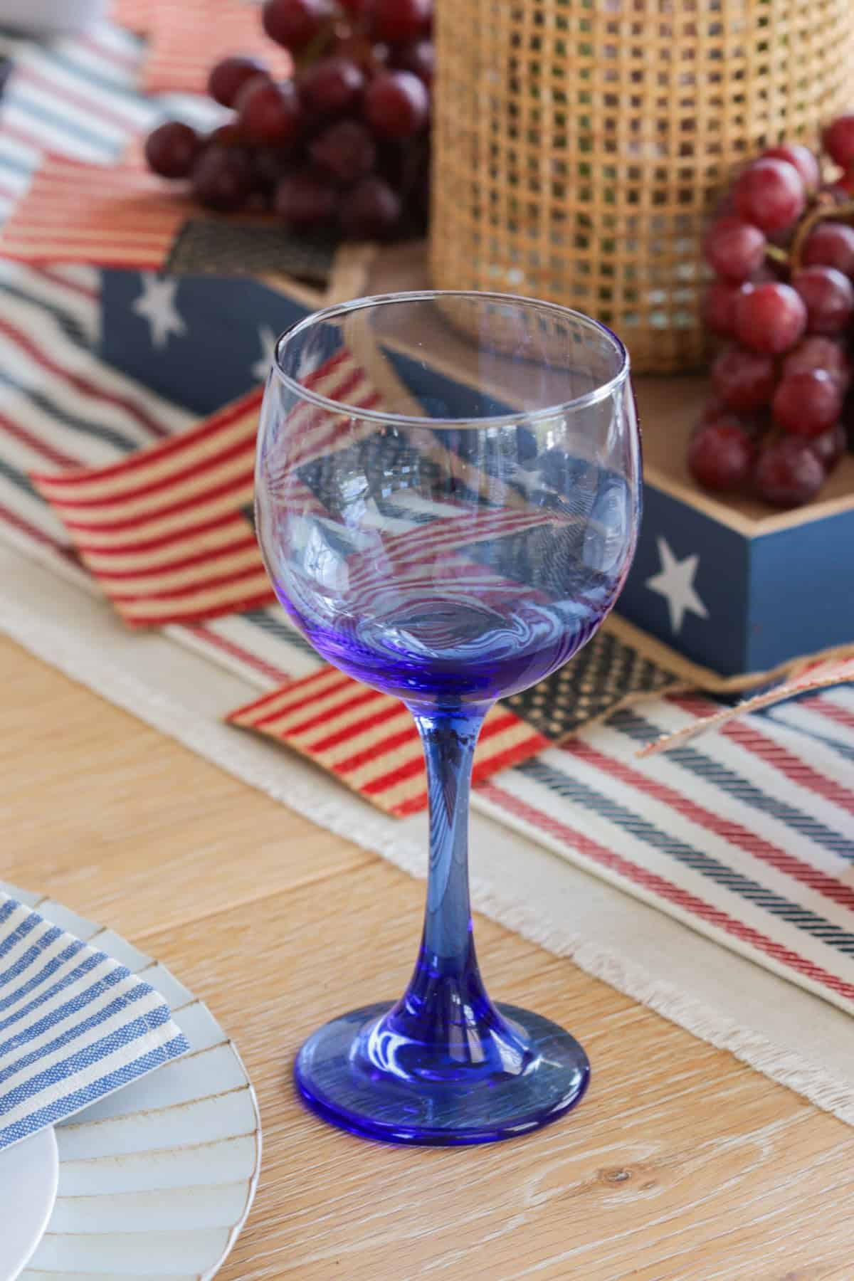 Blue wine glass on table.