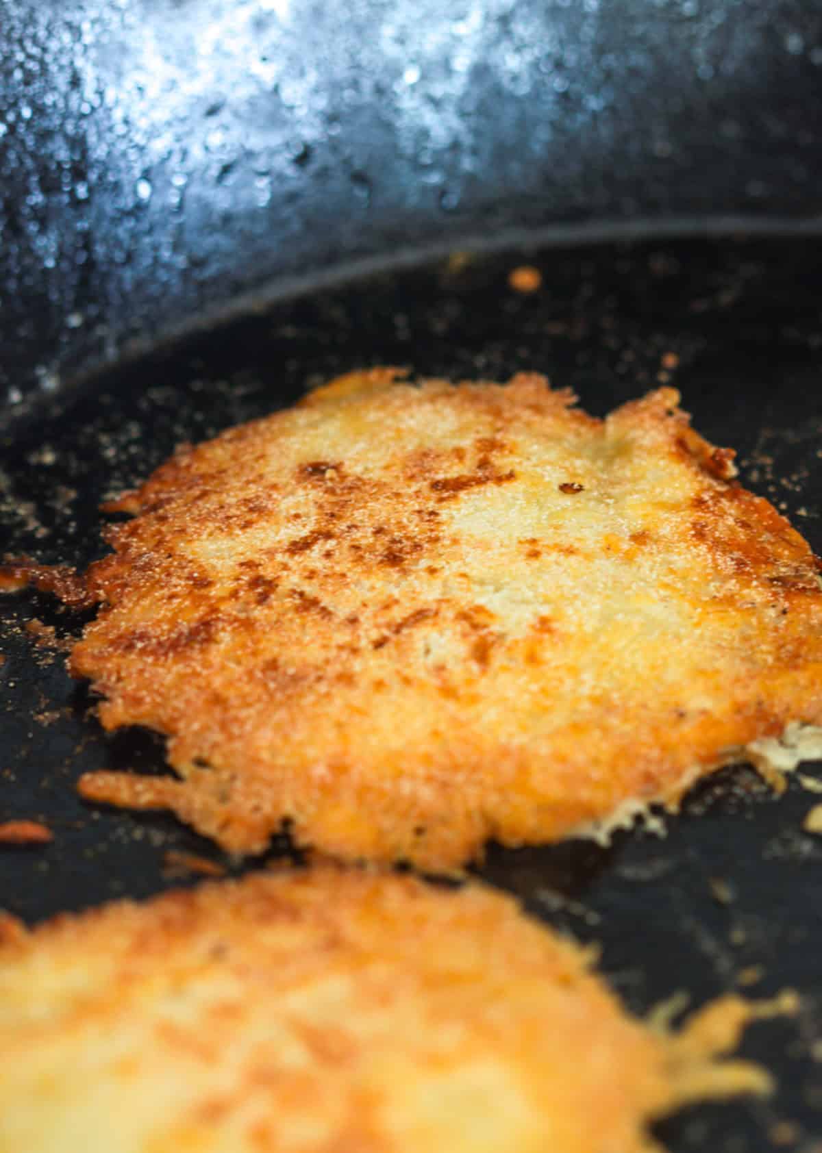 Frying parmesan cheese for taco shells.