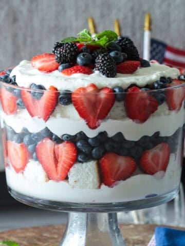 Red white blue layered cake trifle with cream cheese and whipped cream filling.