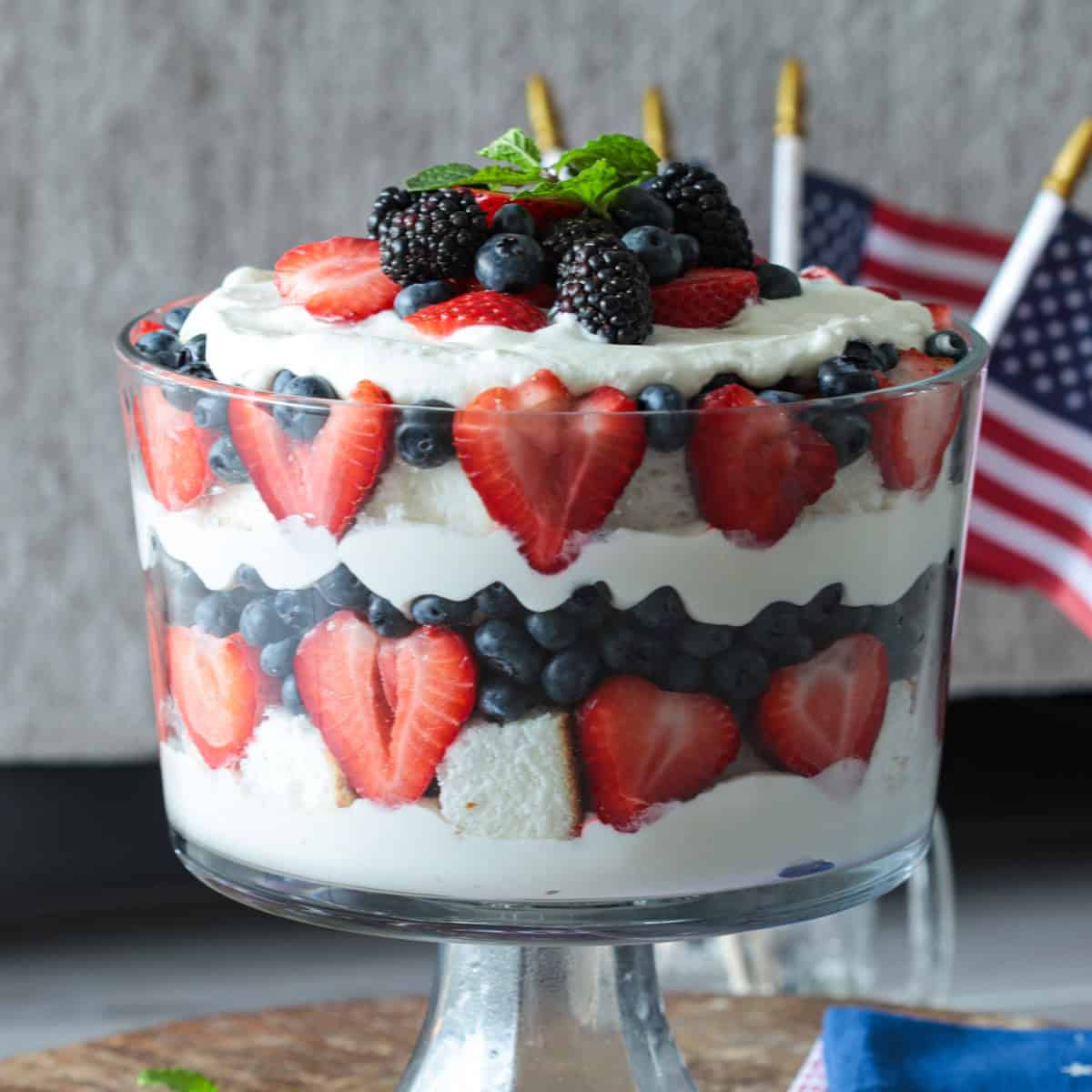 Red white and blue trifle in a trifle dish.