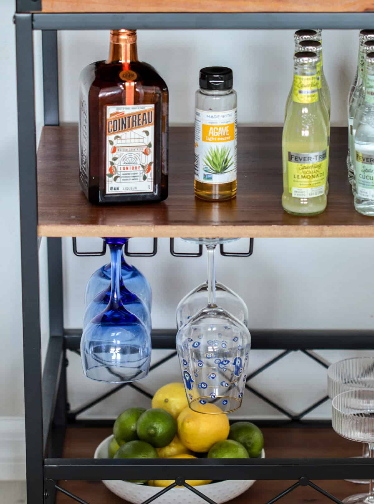 Bar cart with countreau, agave, mixers and glasses.