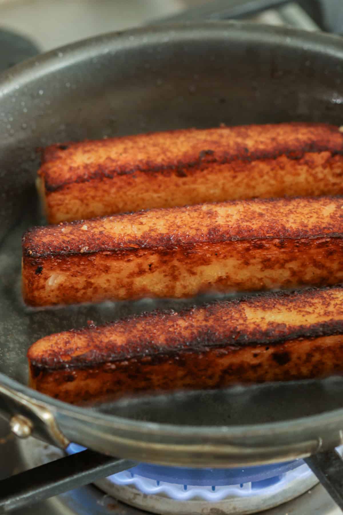 Polenta fries in a nonstick skillet.