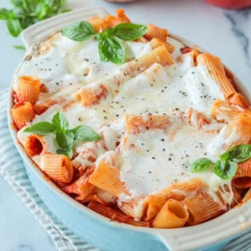 Baked ziti with ricotta cheese in a casserole dish.