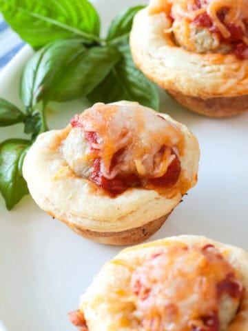 Biscuits stuffed with a mini meatball covered with cheese.