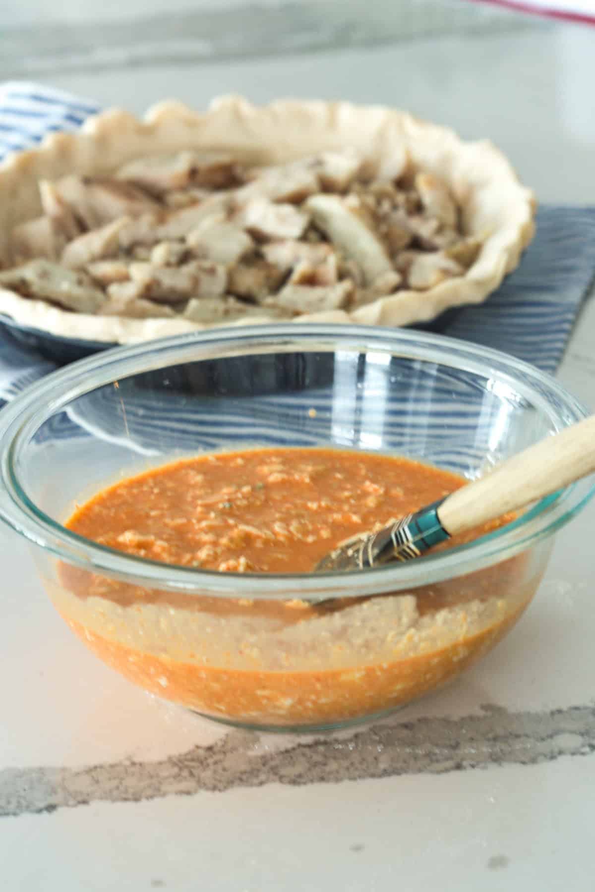 Buffalo chicken mixture in bowl.