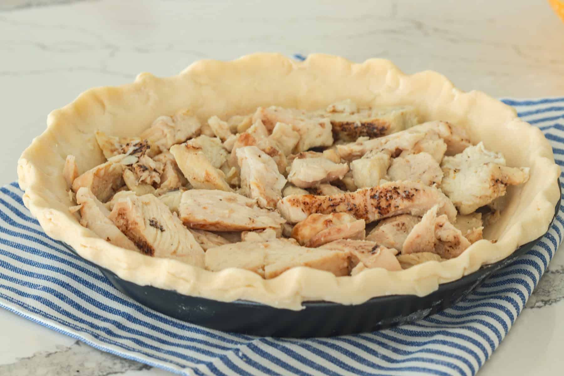 Cooked chicken in pie crust.