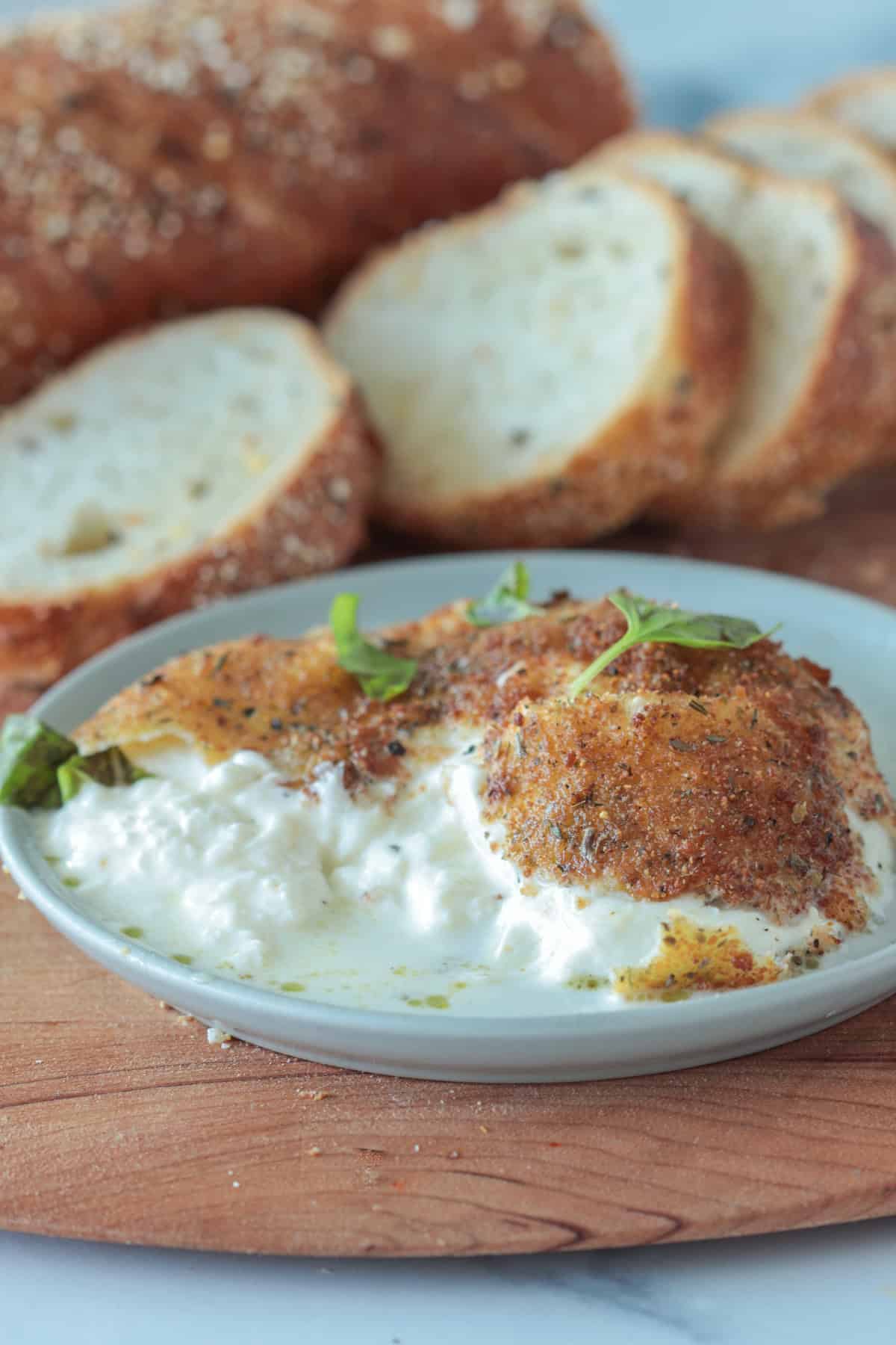 Fried burrata cheese on a plate.