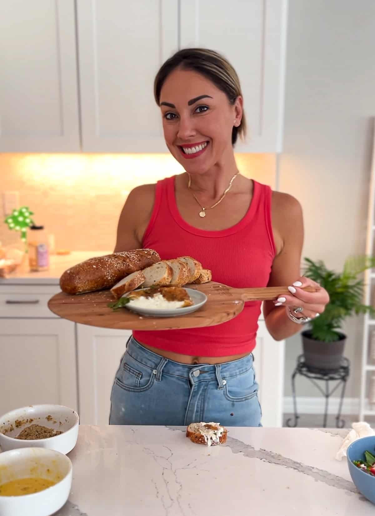 Aleka holding platter of fried burrata and bread.