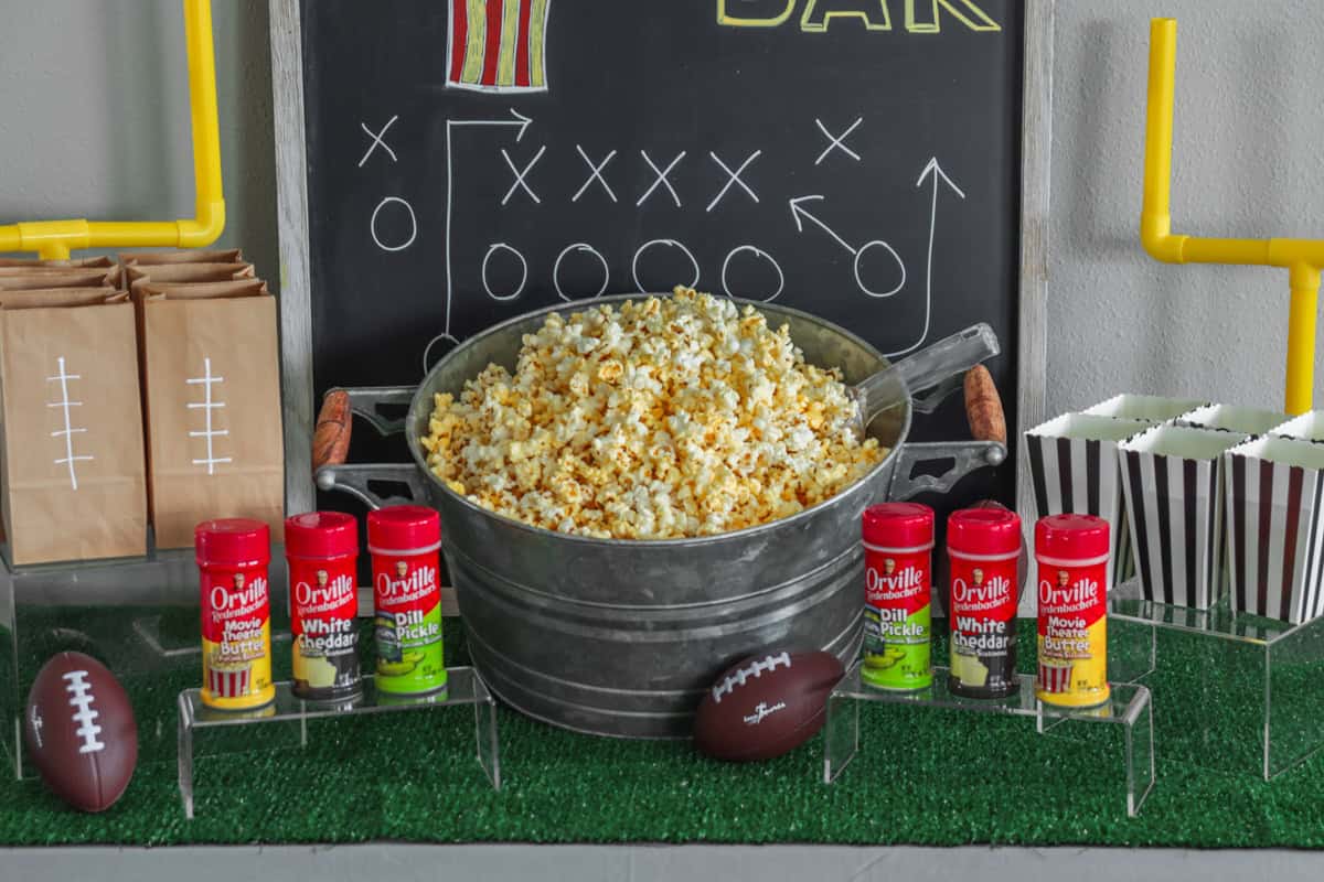 Popcorn bar with popcorn bowl and seasonings.