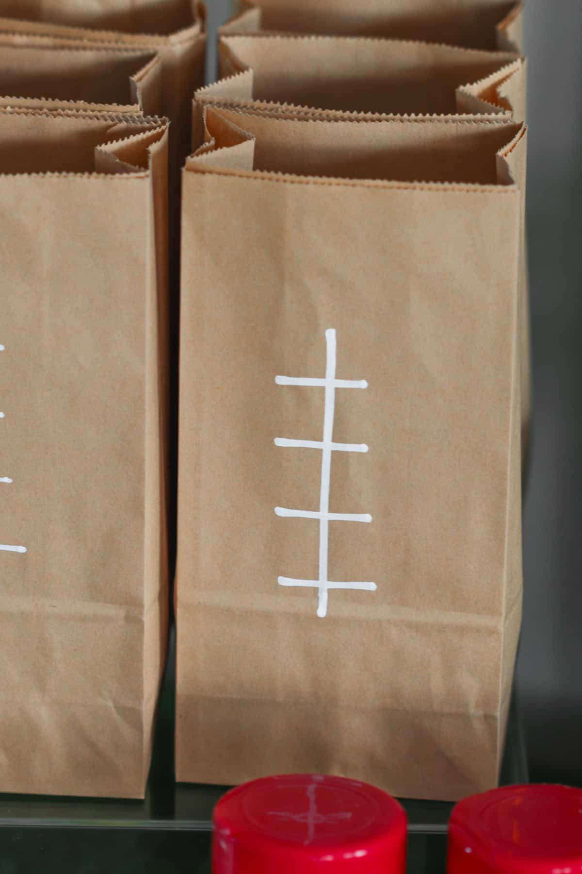 Brown paper bags with white laces drawn.